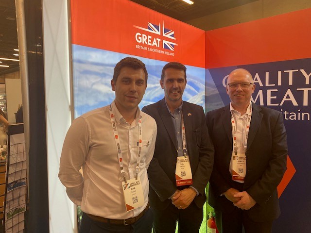 Delegates at AMC Dallas standing in front of quality British meat signs.